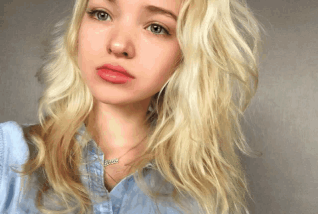 a woman with blonde hair and a necklace that says emma on it