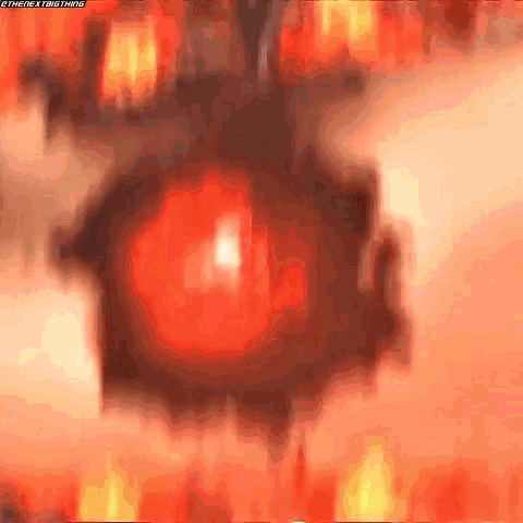 a blurry picture of a red object with flames coming out of it .