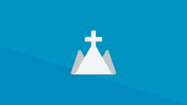 a cross on top of a mountain with a blue background