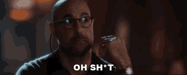 a bald man wearing glasses and earbuds says oh sh * t