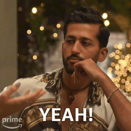 a man with a beard says " yeah " in front of some lights
