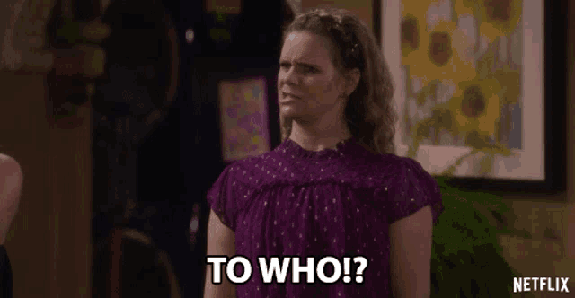 a woman in a purple top says to who