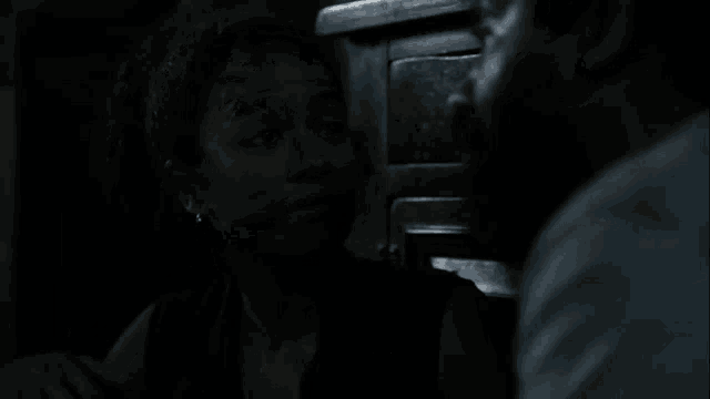 a man and a woman are standing next to each other in the dark and the woman is saying `` we leave here together . ''