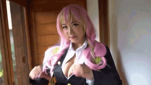 a woman in a pink wig and a black suit is standing next to a window .