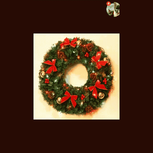 a christmas wreath with red bows on it