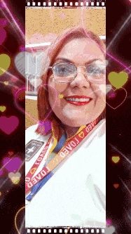 a woman wearing glasses and a lanyard that says toaed on it