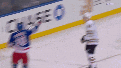 a hockey player with the number 10 on his jersey stands on the ice