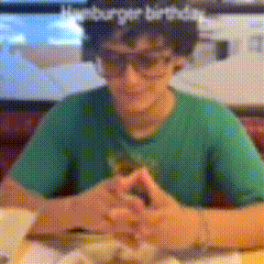 a blurry picture of a person wearing a flower crown and a green shirt with the word burger on it