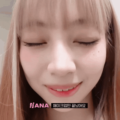 a close up of a girl 's face with nana written on the bottom