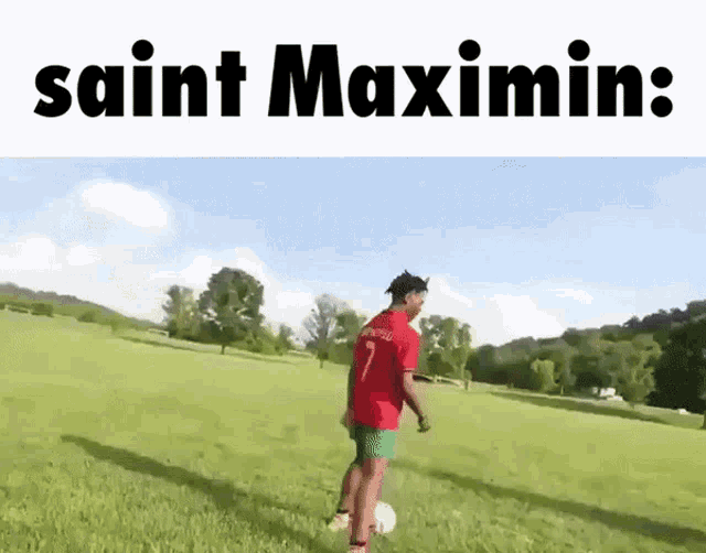 a man in a red shirt with the number 7 on it kicks a soccer ball in a field