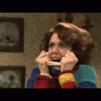 a woman in a colorful sweater is making a funny face