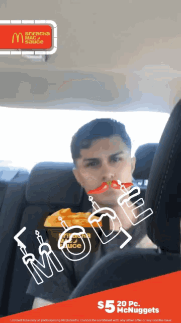 a man is sitting in a car with a mcdonald 's advertisement behind him