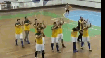a group of soccer players are clapping their hands in the air