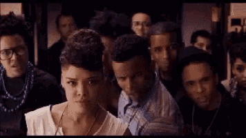 a group of people are standing next to each other in a room .