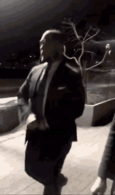 a man in a suit and tie is running