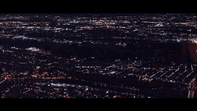 an aerial view of a city at night with the name jordan tyler on the bottom