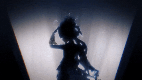 a silhouette of a person in a dark room with a light behind them
