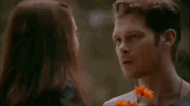 a man and a little girl are looking at each other .