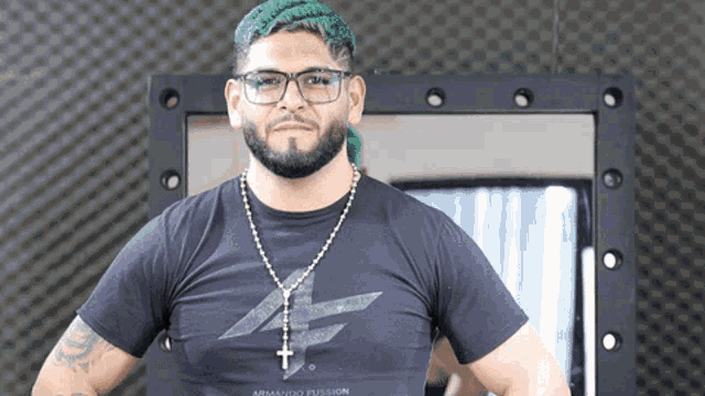a man with green hair is wearing glasses and a black shirt that says armando fusion