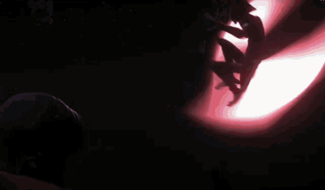 a man in a helmet is holding a light saber