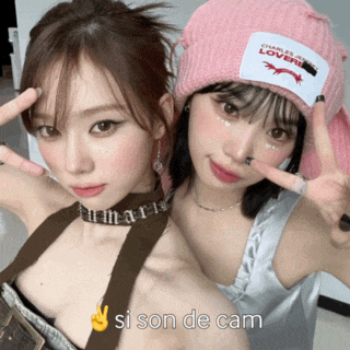 two girls are posing for a picture and one of them is wearing a pink hat that says " charles & lovers "