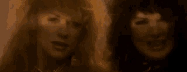 a close up of two women with their mouths open .