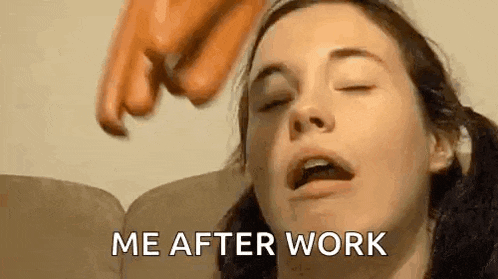 a woman is sitting on a couch with her eyes closed and a hand reaching into her mouth .
