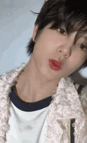 a close up of a person 's face with red lipstick on .