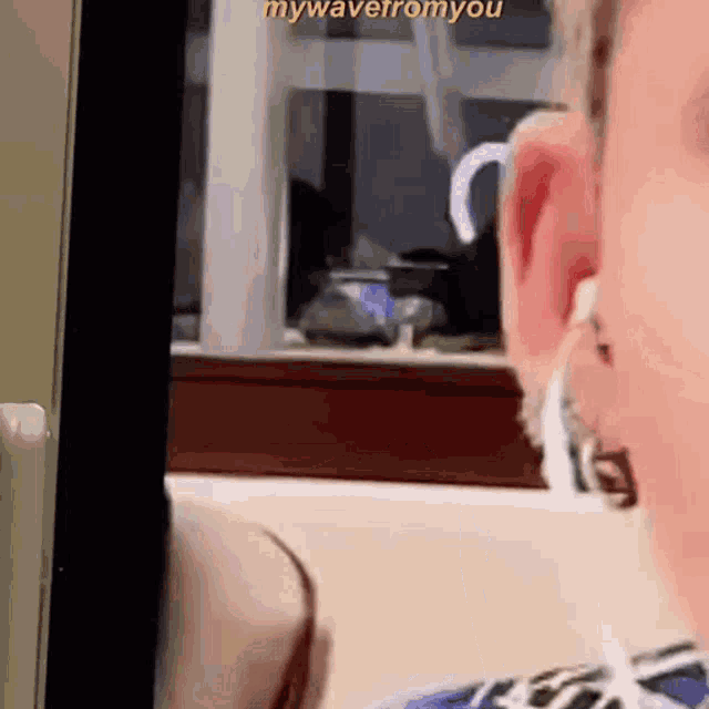 a close up of a person 's ear with the words " mywavefromyou " on the bottom