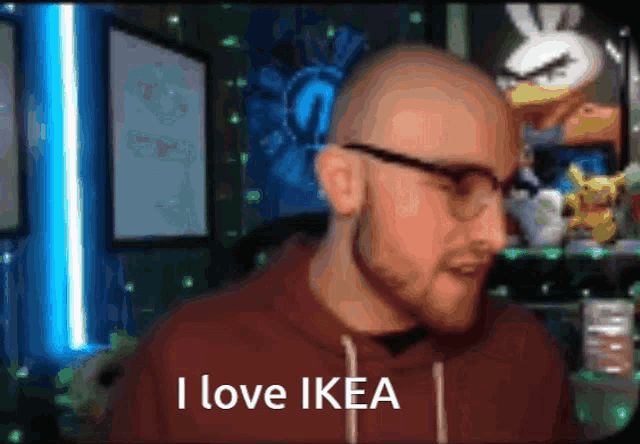 a bald man wearing glasses says " i love ikea "