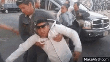 a group of people are standing in front of a car .