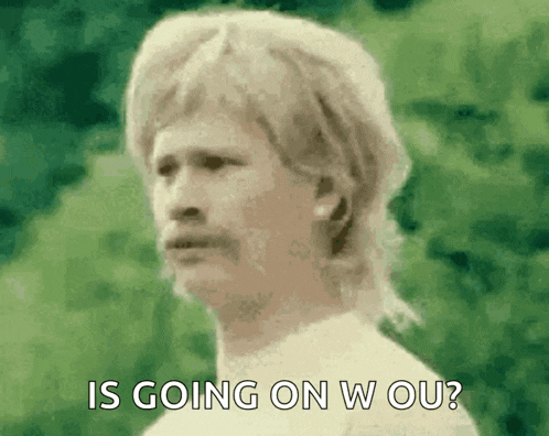 a man with a mullet and mustache says is going on w ou