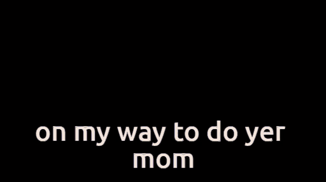 a man in a suit and tie is sitting at a table and says " on my way to do yer mom "