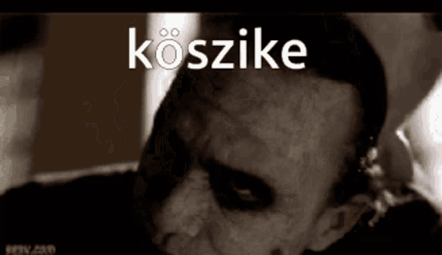 a close up of a man 's face with the word koszike above it