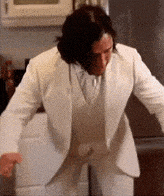 a man in a white suit is standing in front of a refrigerator