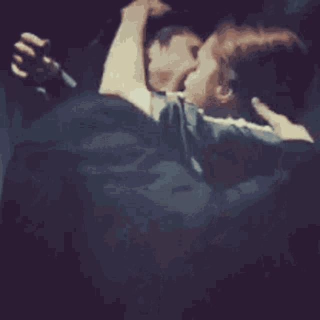 a man and a woman are kissing in the dark