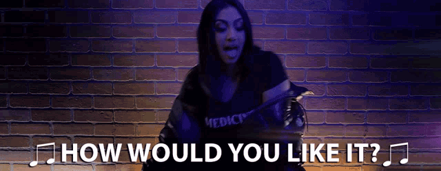 a woman is dancing in front of a brick wall with the words " how would you like it "
