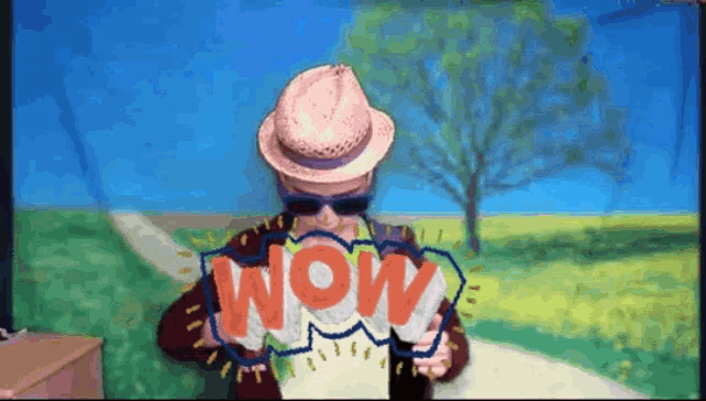 a man wearing a hat and sunglasses is holding a speech bubble that says wow