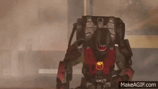 a robot with a crown on its chest is standing in a room with smoke coming out of it 's mouth .