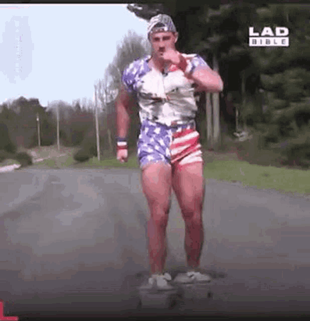 a man in an american flag outfit is riding a skateboard on a road .