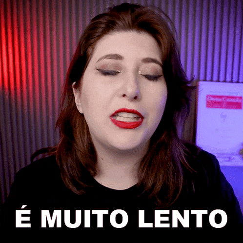 a woman with red lipstick is standing in front of a sign that says é muito lento