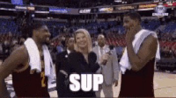 a woman is talking into a microphone while two basketball players are standing next to each other and the word sup is on the screen