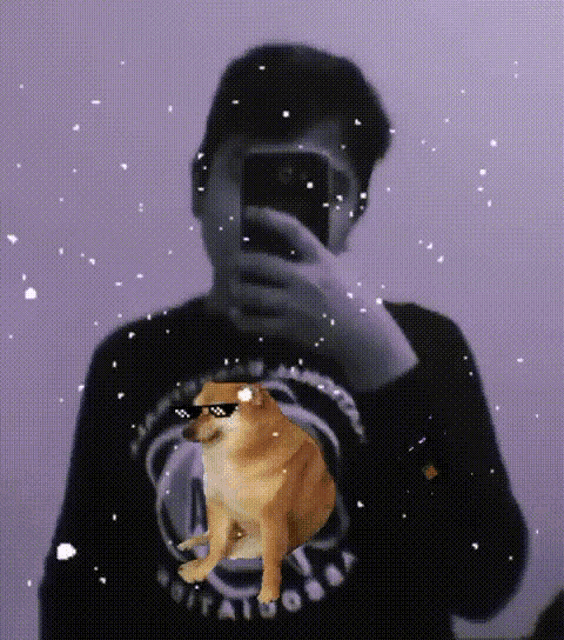 a man taking a picture of himself with a dog on his shirt that says potatoes