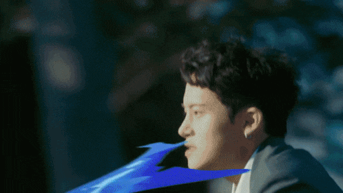 a person is riding a bike down a street with blue waves coming out of it