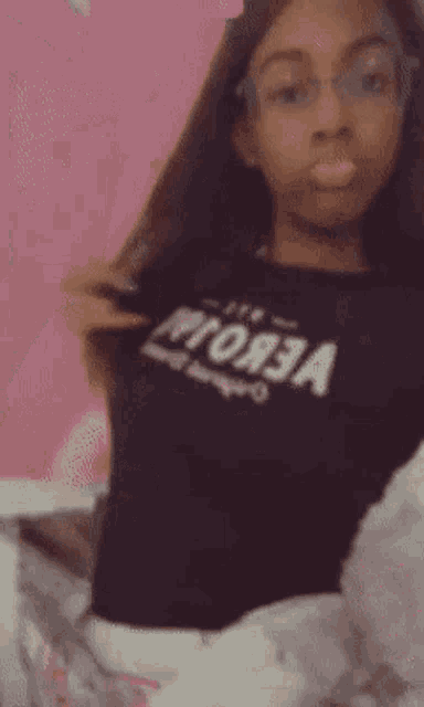 a girl wearing glasses and a black t-shirt with the word vega on it
