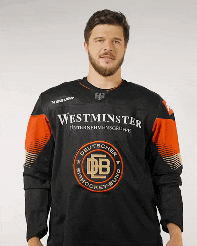 a man is wearing a black and orange westminster unternehmensgruppe jersey