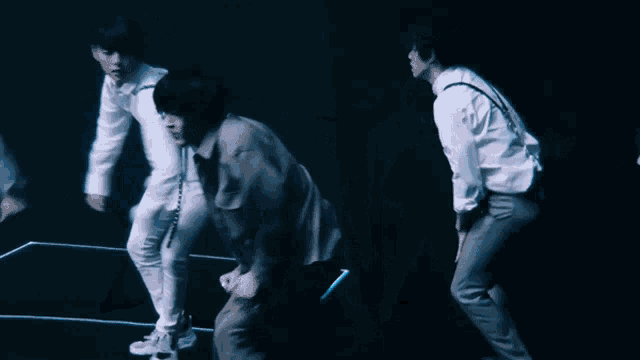 a group of people are dancing in a dark room