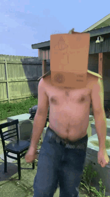 a man without a shirt is wearing a cardboard box on his head with the number 1 on it