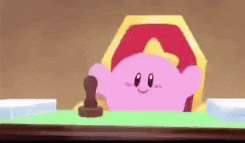 a pink cartoon character is sitting at a table with a stamp on it .