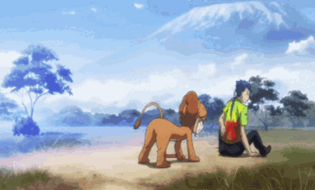a man sits next to a lion in a field